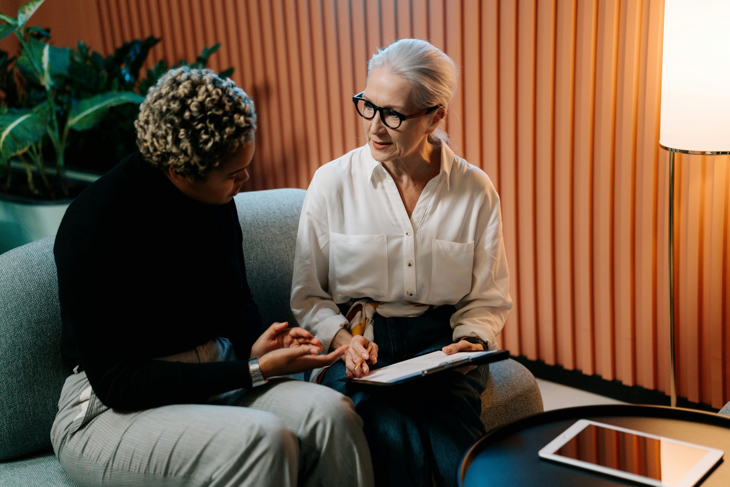 Two people in conversation representing resident and tenant communication for Delisa Miller Block Management services