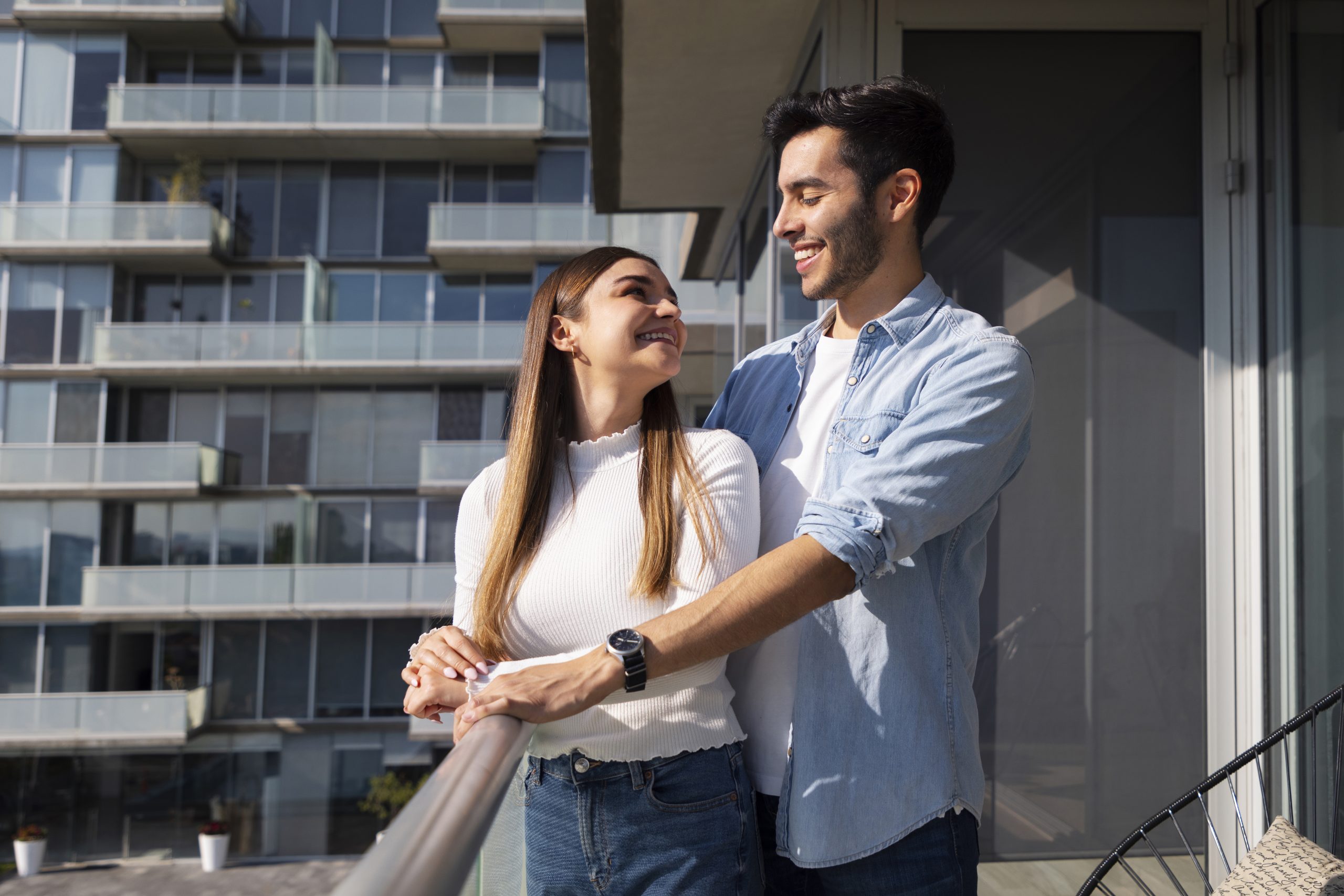 Happy Couple Buying a Home – Delisa Miller Estate Agents Manchester Smiling couple receiving keys to their new home in Manchester, supported by Delisa Miller estate agents