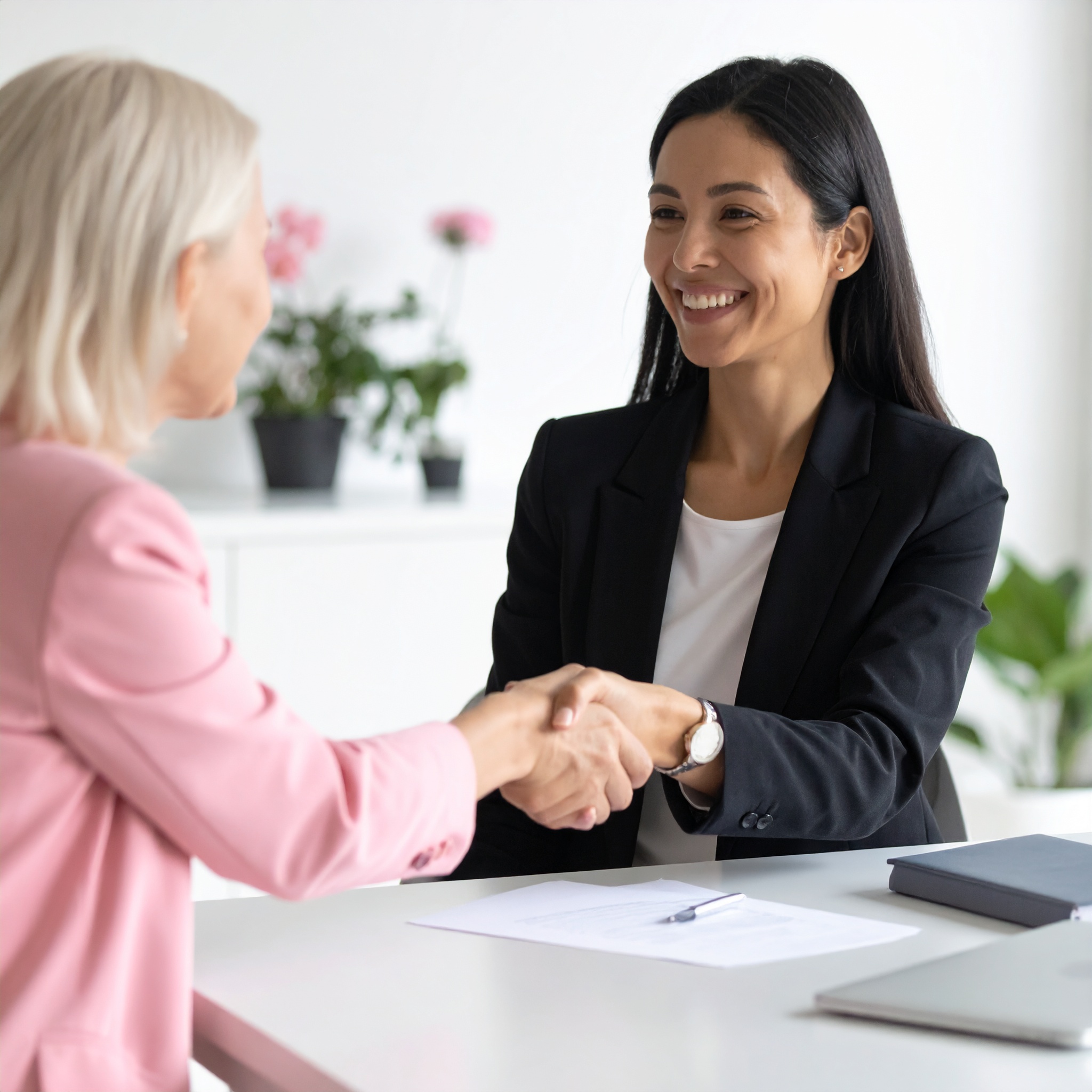 Professional insurance advisor shaking hands with a satisfied client, symbolising fast and reliable insurance service from Delisa Miller